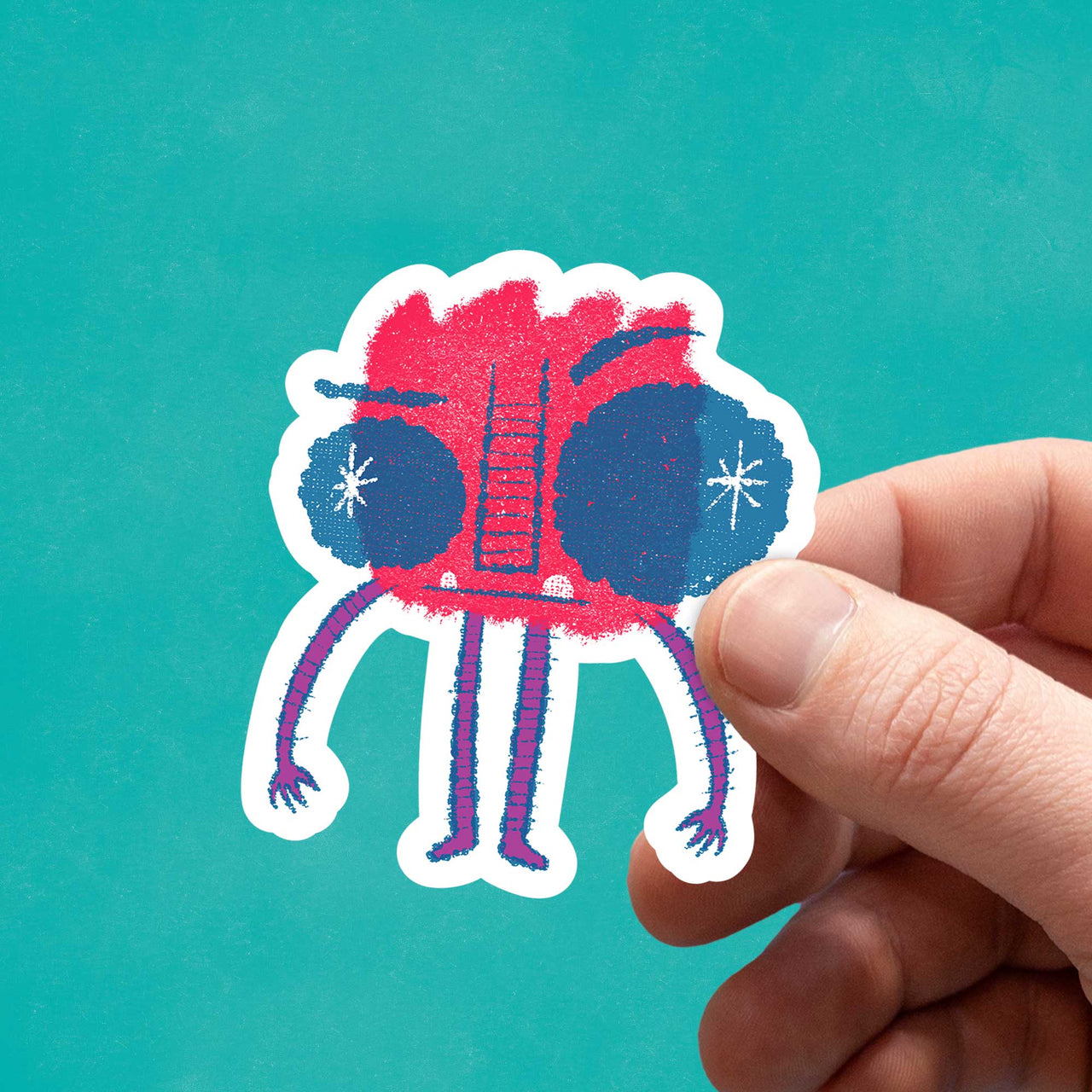 a red monster sticker in hand