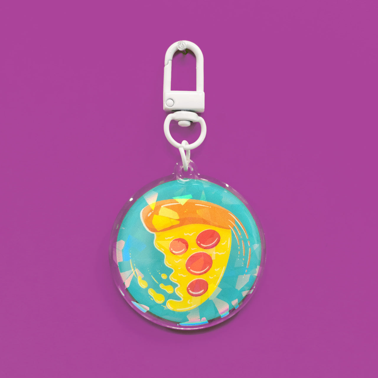 swirling pizza art on a circular holographic keychain
