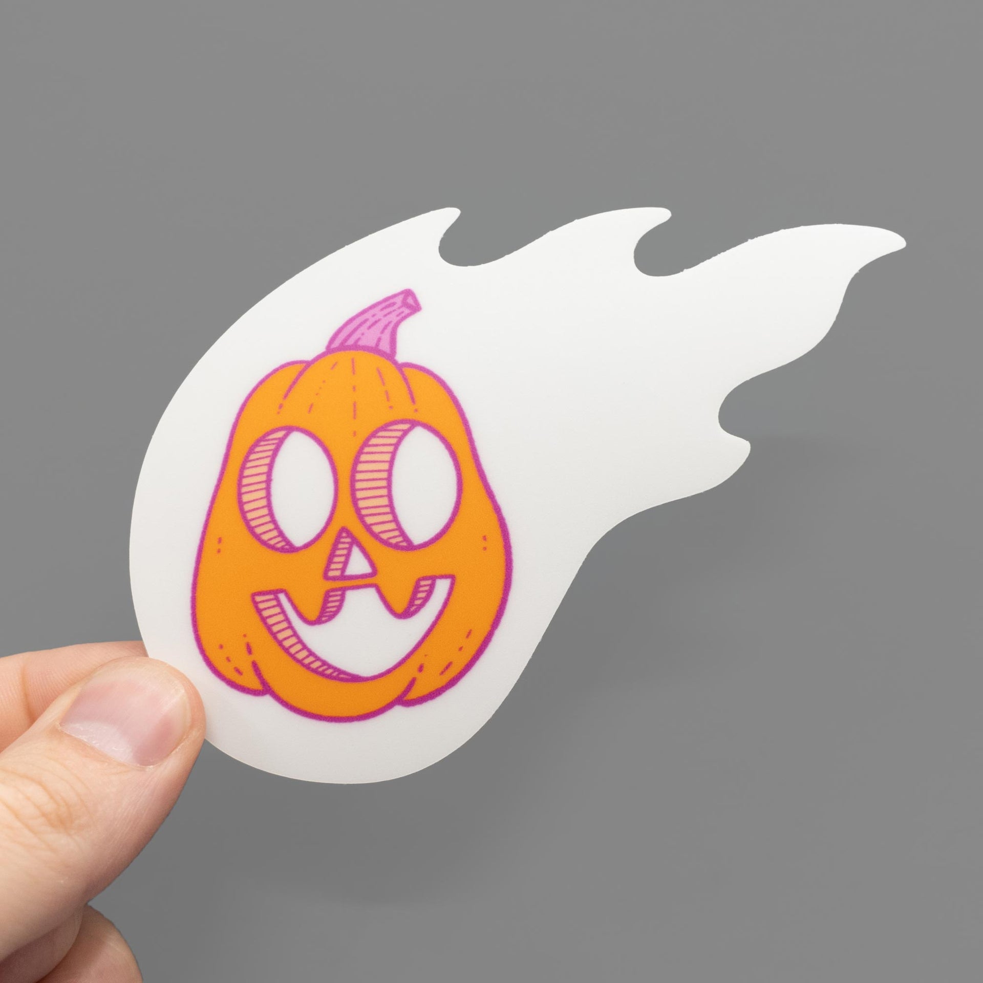 flaming pumpkin in glow in the dark fire sticker in hand