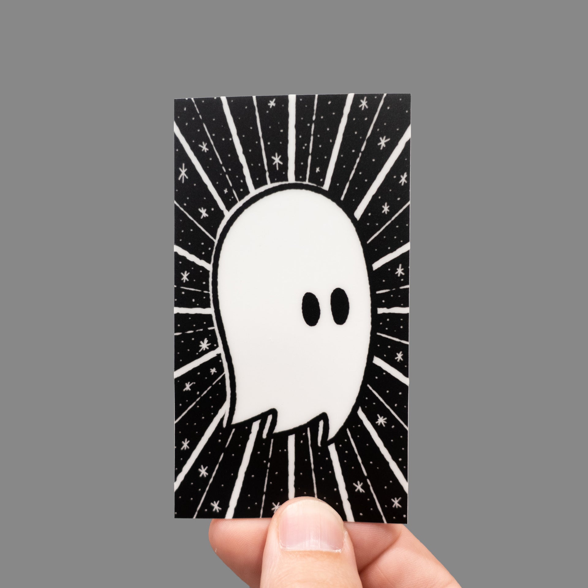 rectangular glow in the dark ghost sticker in hand