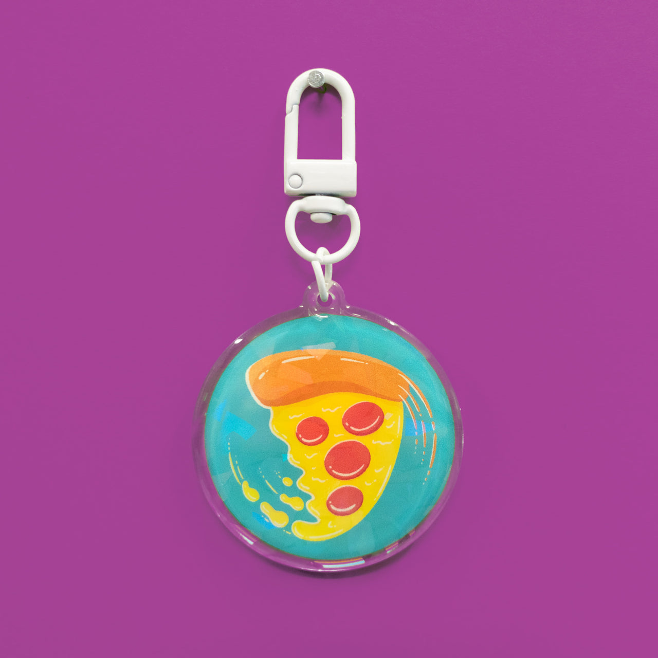 swirling pizza art on a circular holographic keychain