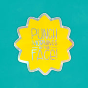 a holographic starburst sticker that says "punch mornings in the face"