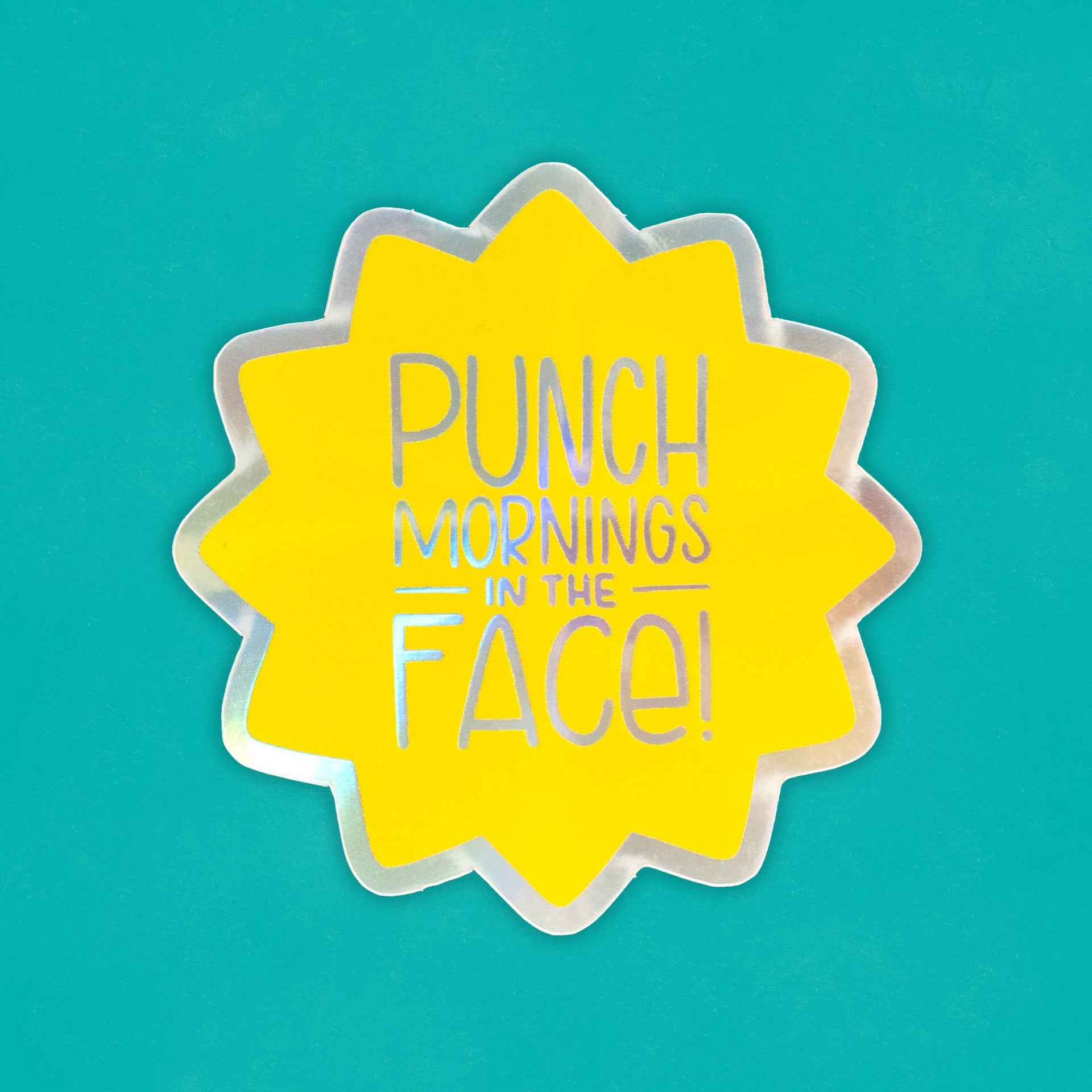 a holographic starburst sticker that says "punch mornings in the face"