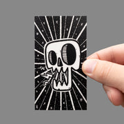 rectangular glow in the dark skull sticker in hand